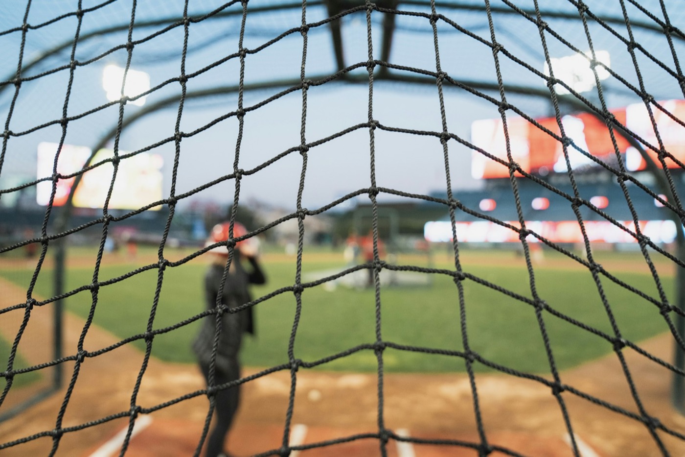 The baseball field at Angel Stadium seen through the batting cage net