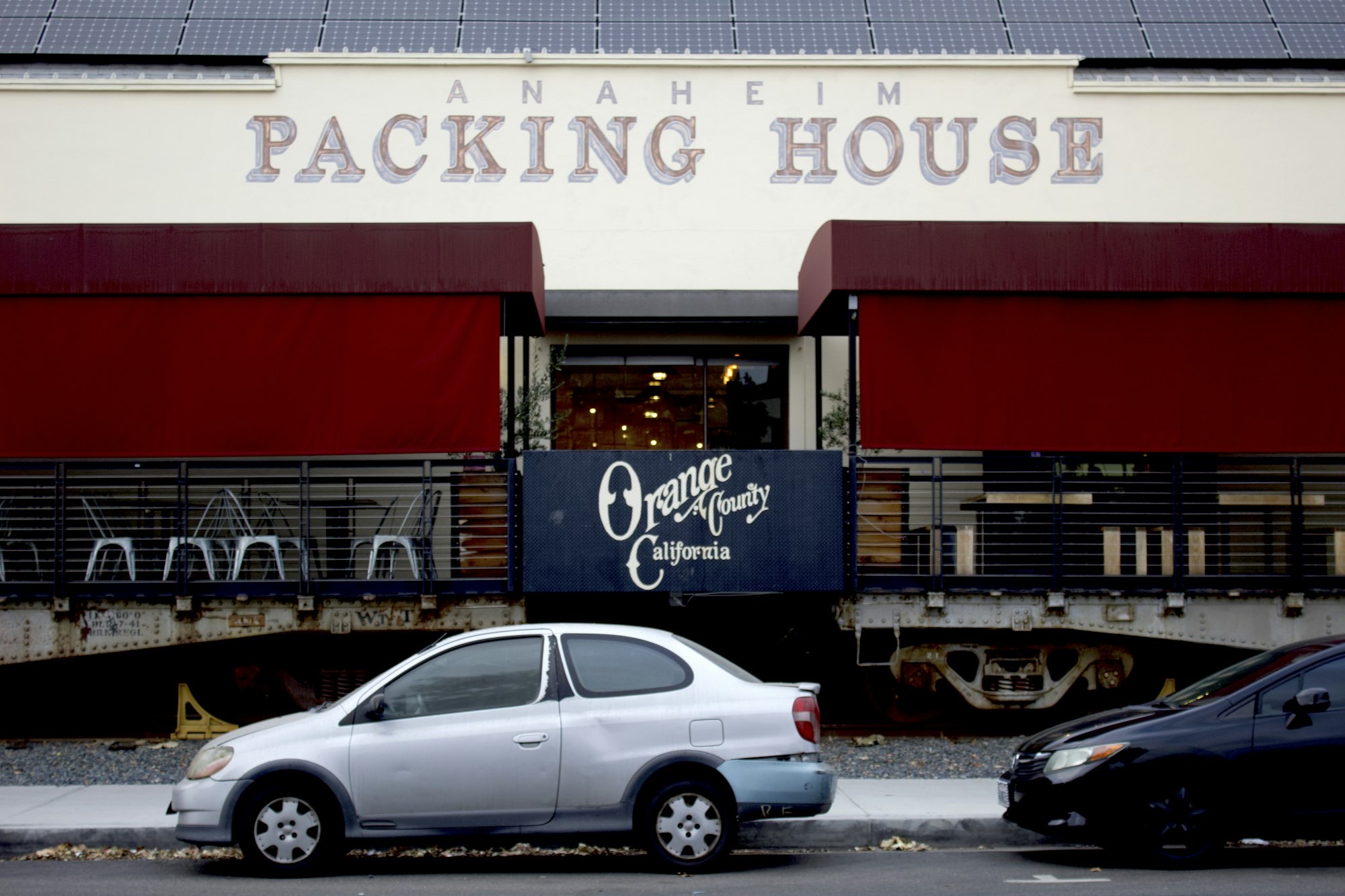 The Anaheim Packing House with its painted sign and an Orange County California sign below