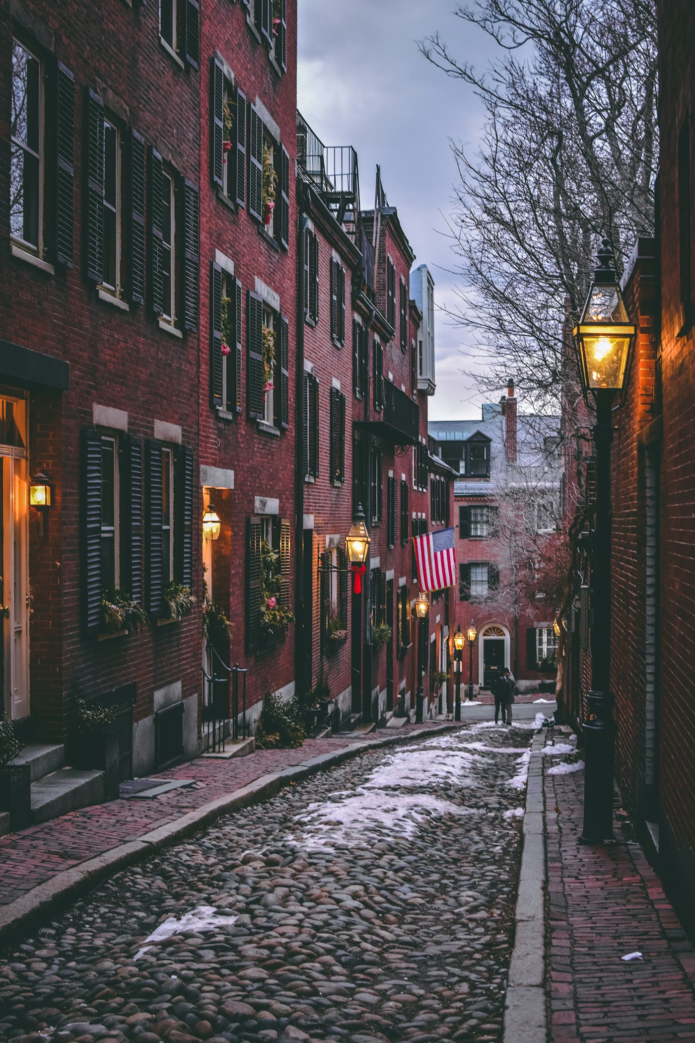 Gas lamps and brick row houses along the cobblestones of Acorn Street on Beacon Hill