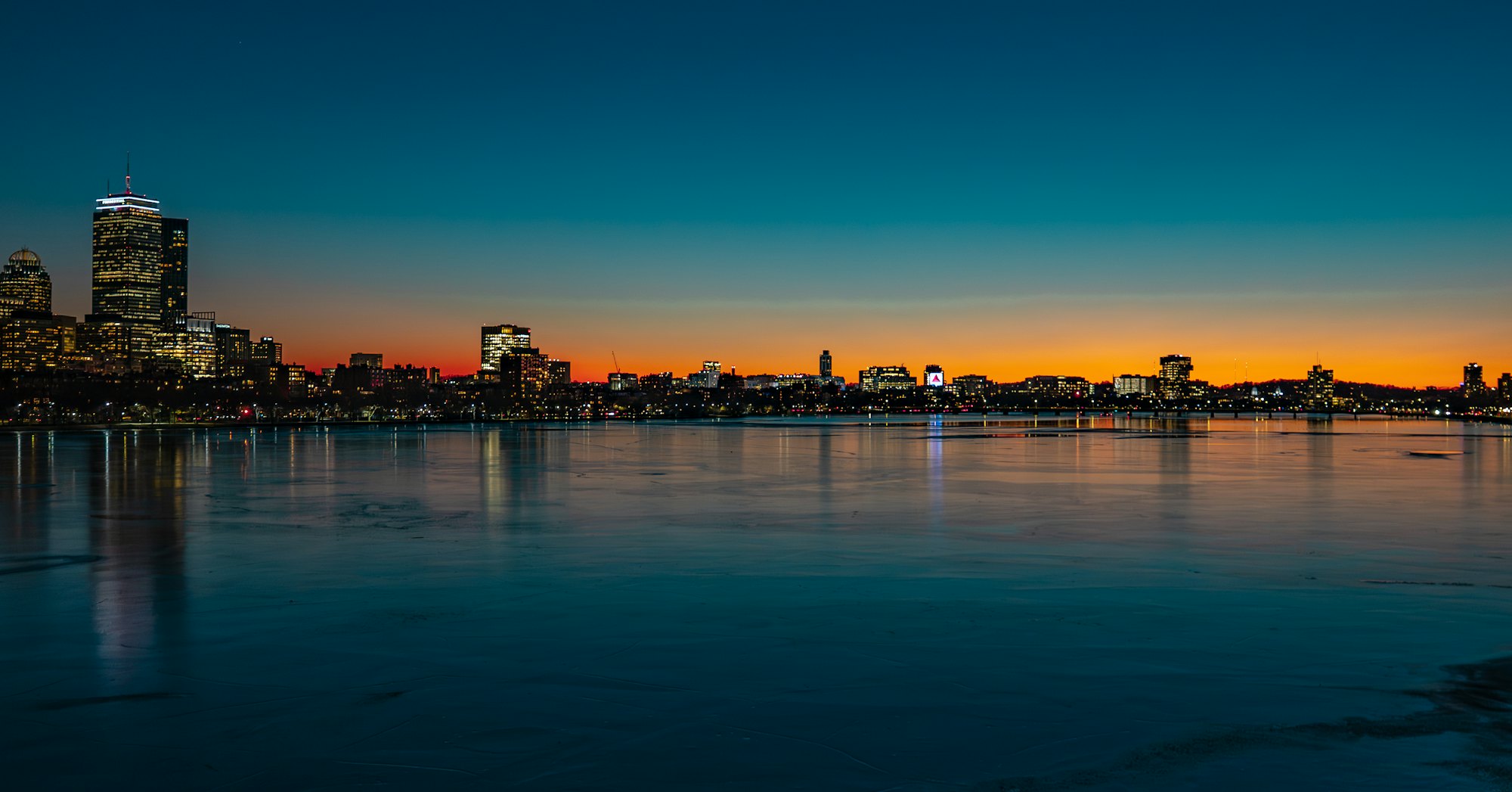The Boston skyline across the frozen Charles River at sunset