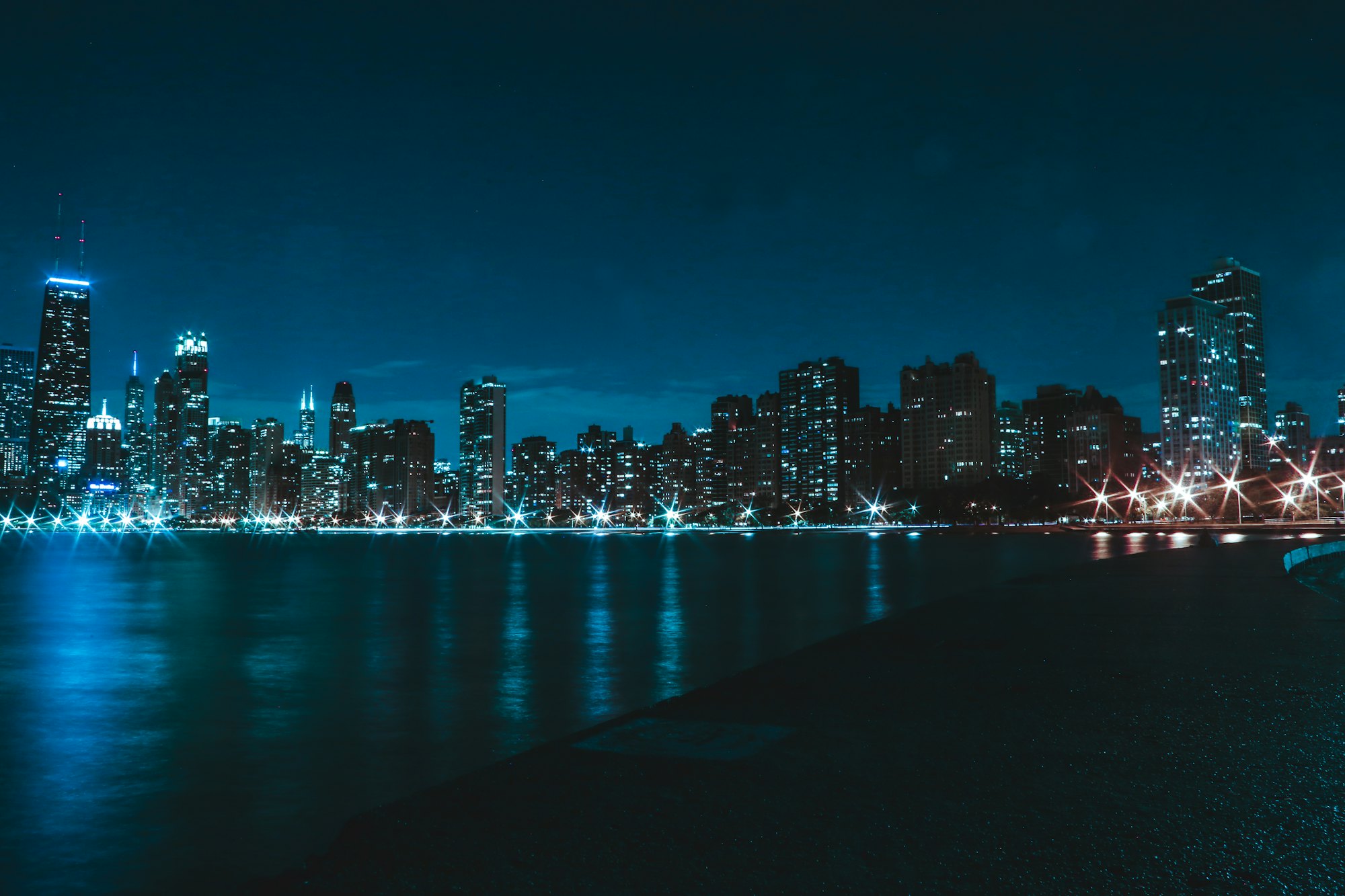 The Chicago skyline lit up at night across the water