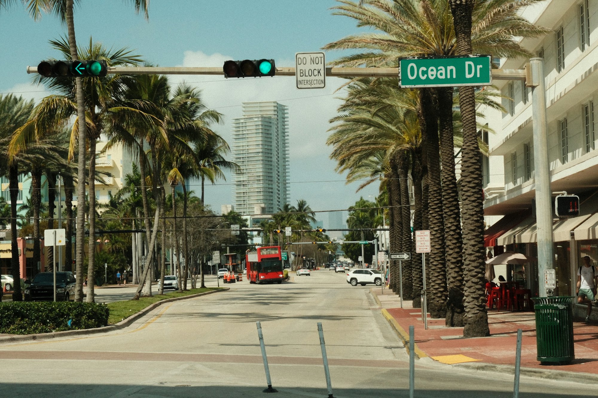 Palm trees lining Ocean Drive in Miami Beach under a bright sky