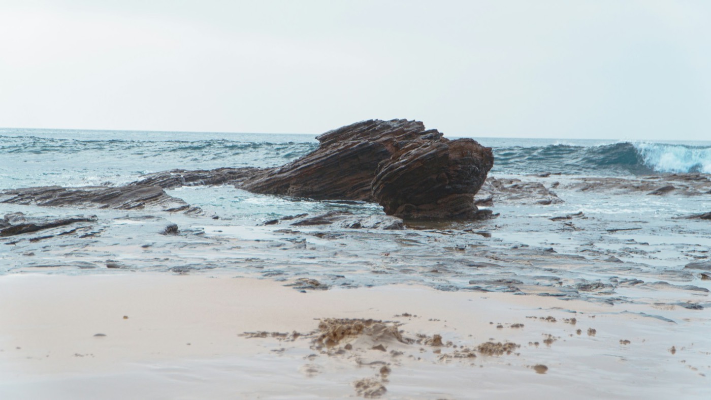 A layered rock in the surf at Crystal Cove
