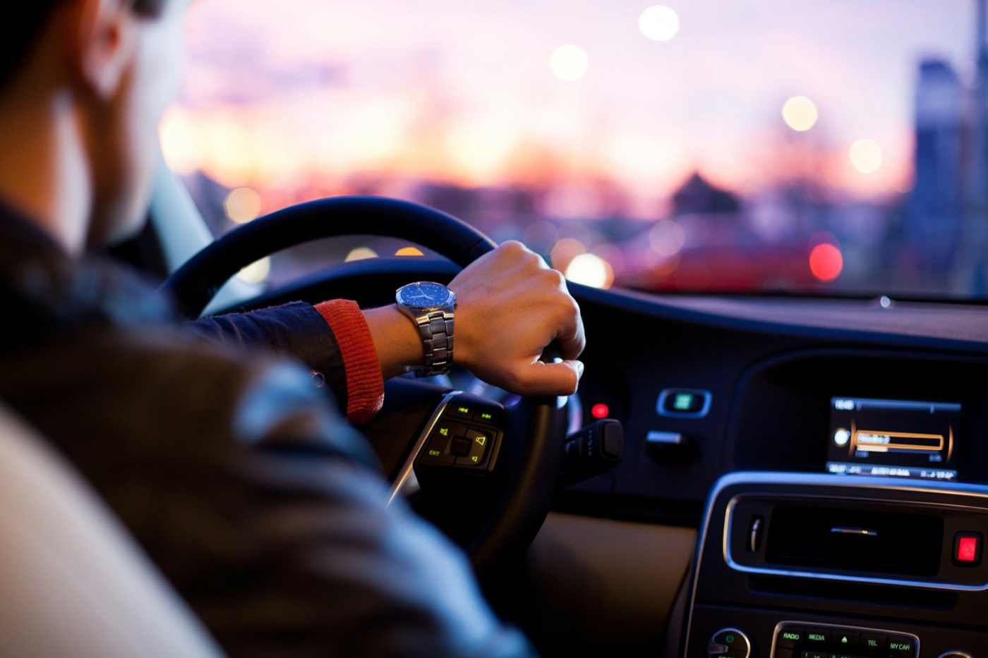 A professional driver with both hands on the wheel